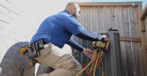 HVAC Tech working on unit with equipment in backyard