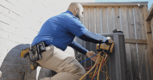 HVAC Tech working on unit in backyard with equipment