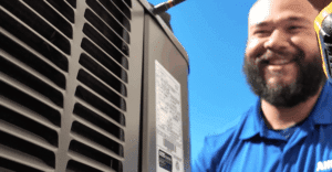 HVAC Tech Smiling at Work on Unit